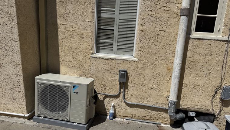 Daikin mini-split outdoor condenser on wall