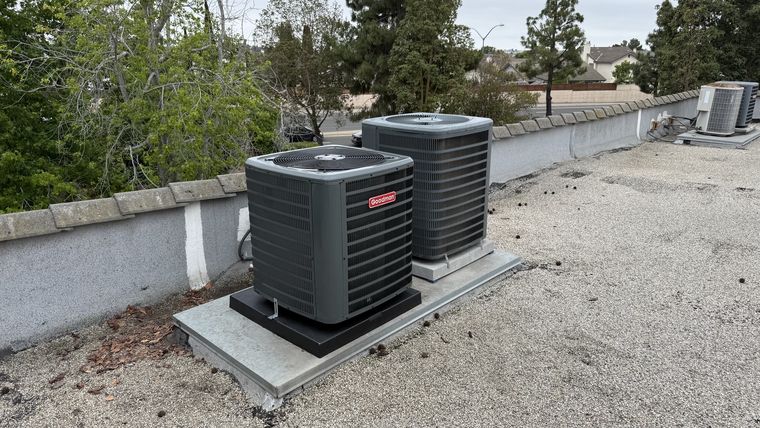 Two new Goodman AC condensers on rooftop