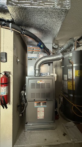 Closet gas furnace beside water heater
