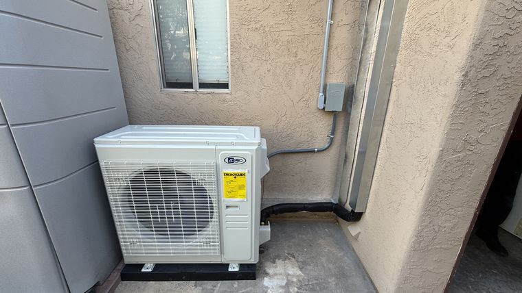 Outdoor mini-split condenser by wall