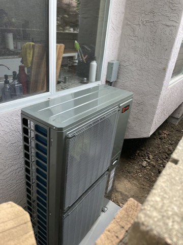Trane AC condenser beside window