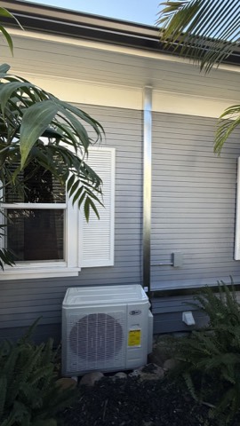 AC Pro mini-split condenser beside house
