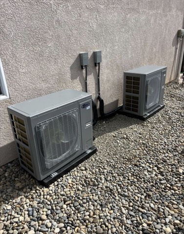 Two mini-split condensers on gravel