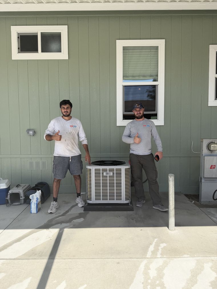 Two techs thumbs-up by AC unit